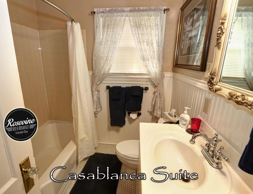 The Casablanca bathroom features a white tub shower combo, commode and sink