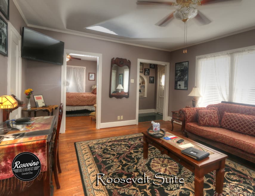Living Room with red sofa, wood tv table on top a decorative rug