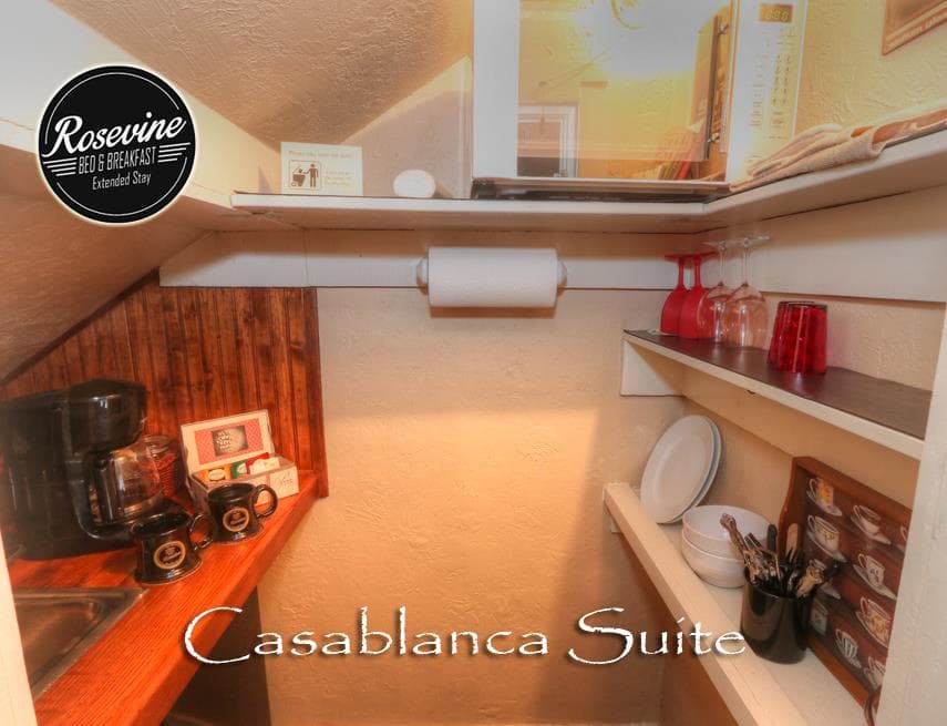 The casablanca suite has a built in mini kitchen that has a mini sink, microwave, mini fridge and cutlery
