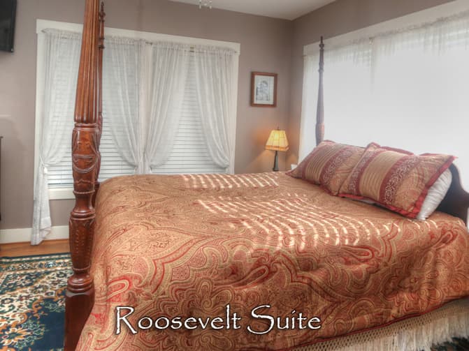 Four poster wood bed with gold and yellow duvet
