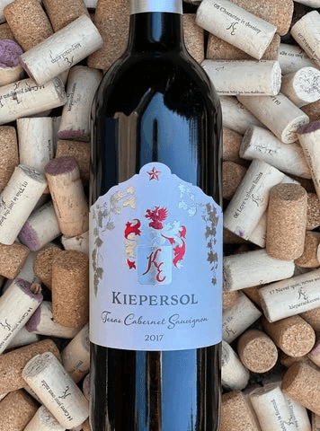A bottle of Kiepersol 2017 Texas Cabernet Sauvignon surrounded by wine corks.