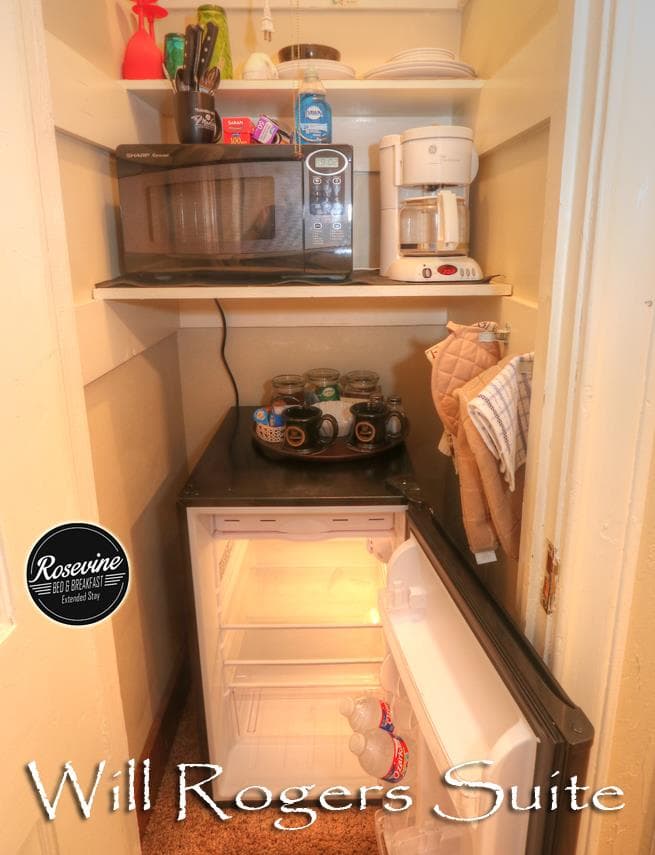 Will Rogers closet with black mini fridge, microwave, coffee pot, coffee mugs and utensils