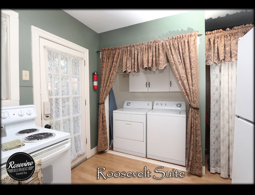 The roosevelt kitchen has a white washer and dryer