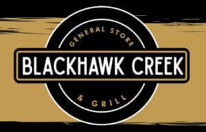 rectangular sign black at the top and bottom the middle is brown this is the background-a circle in the middle says at the top General Store at the bottom & Grill in the middle across the circle the words Blackhawk Creek