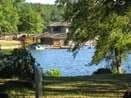 photo of the Lake at Tyler State Park. Trees in the foreground and bath house in the background