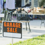 garage sale sign with furniture in the background