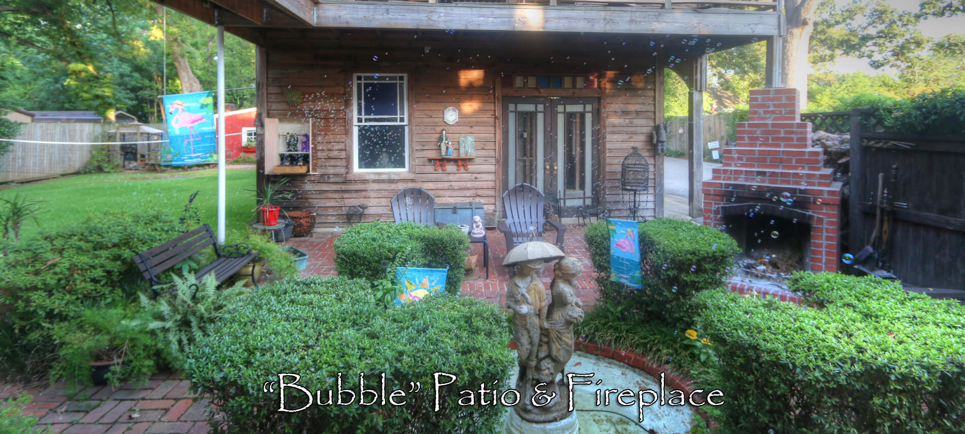 Brick patio with a garden fountain, fireplace, bubbles and chairs