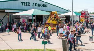 scene from Canton trade days people walking around in feont of the entrance to the Arbors building