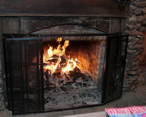 ROARING FIRE IN OUTDOOR FIREPLACE AT ROSEVINE INN