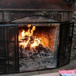 Fireplace with a beautiful fire =phot taken at The Rosevine Inn