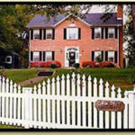 Red Brick Georgian Home-The Rosevine Inn-white picket fence out front