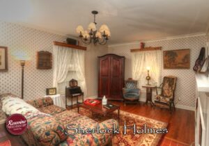 Sherlock Holmes Living Room with rug, couch, blue chair and tv cabinet