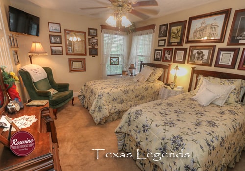 Texas Legends room with two twin beds, dresser, and green wingback chair