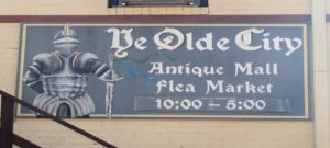 Ye Olde City Antique Mall Sign with hours 10 - 5 a knight in armour is on the sign