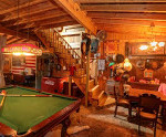 Barn Gameroom at Rosevine Inn Stairs pool table fireplace.