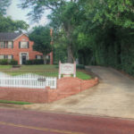 Front yard view Rosevine Inn-Red Brick. White picket Fence