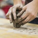 Hands forming clay