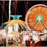 Images of the fair including a faris wheel and othe rides and lights