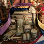 sewing box surrounded by fabric and ribbons