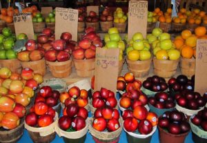 many kinds and colors of fruit in baskets