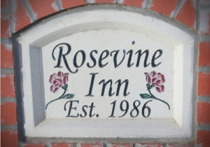 white plaque sways Rosevine Inn Est. 1986 roses on each side