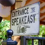 sign says Entrace to Speakeasy with a hand pointing