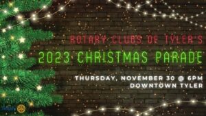 retangular sign with black starry background christmas tree on the left and white light hanging down. Says in red Rotary Club of Tyler, then in green says 2023 Christmasd parade, then under that in white says Thursday, Niovember 30 @6pm Downtown Tyler